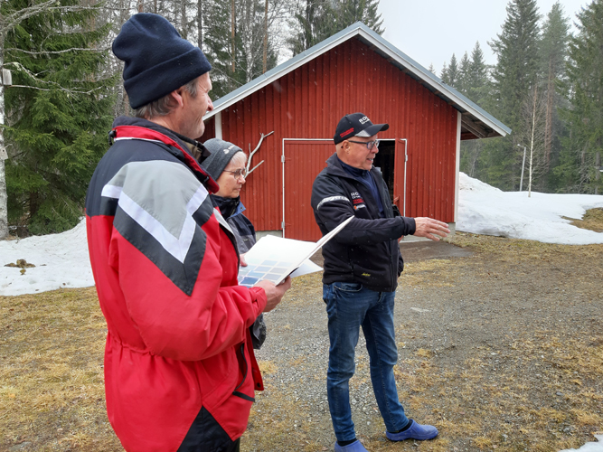 Kivijalka tummanharmaaksi. Onni Törrönen, Anita Heikkinen ja Asko Räty keskustelivat, mitä muuta kylätalon kivijalka kaipaa kuin maalia.